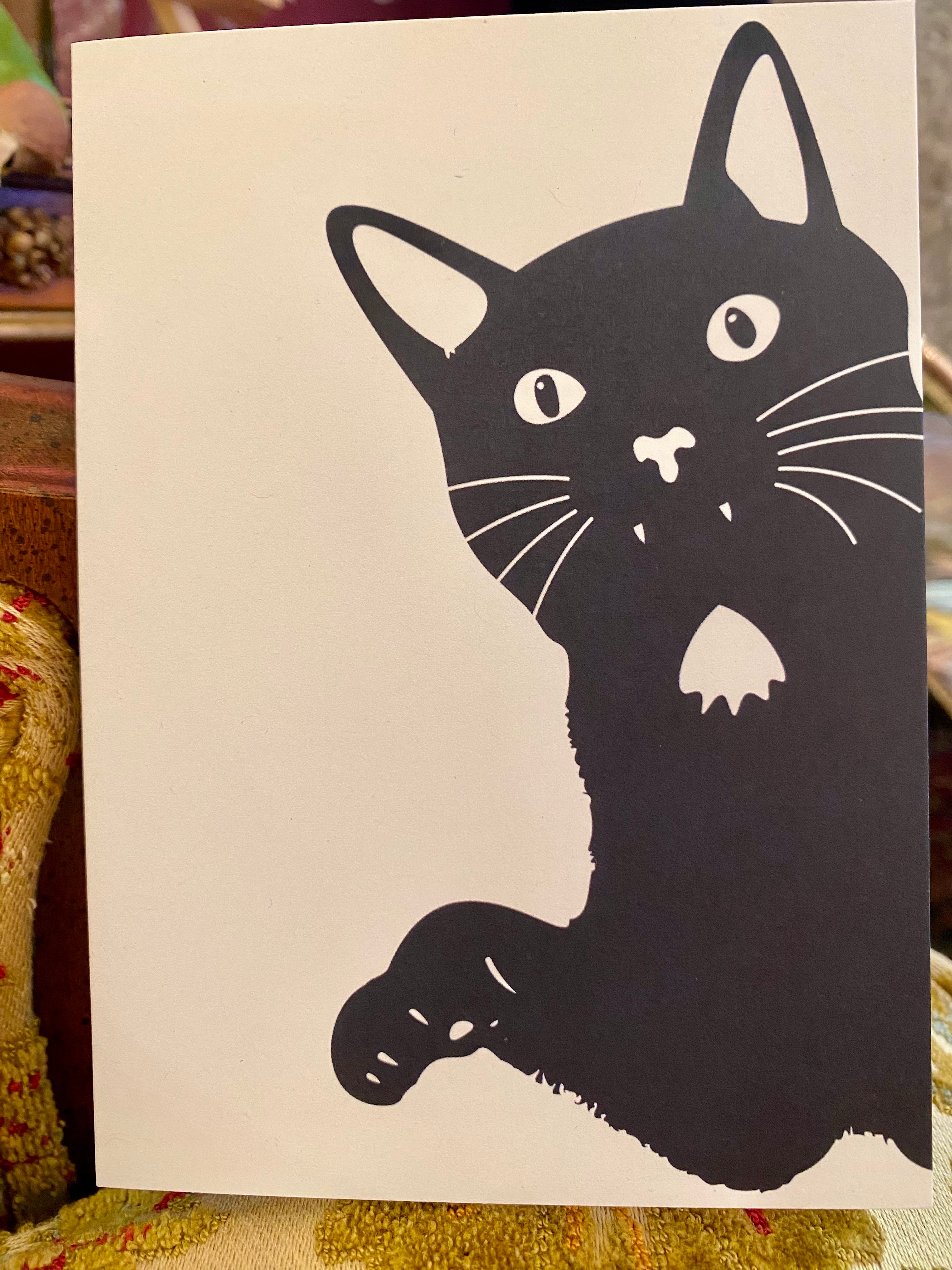 Black cat illustration on a beige card